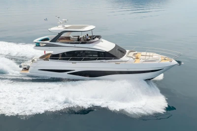 2025 Princess F65 yacht cruising on calm waters, showcasing luxury design and sleek performance.