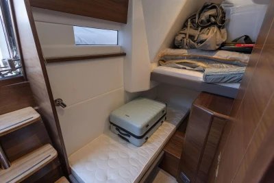 Luxurious cabin interior of 2025 Princess F65 yacht with luggage and storage space.