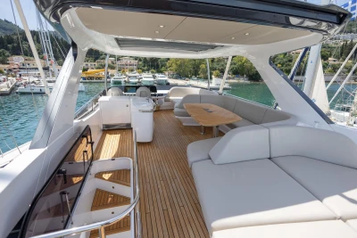 Luxurious 2025 Princess F65 yacht with spacious deck and elegant seating in a marina setting.