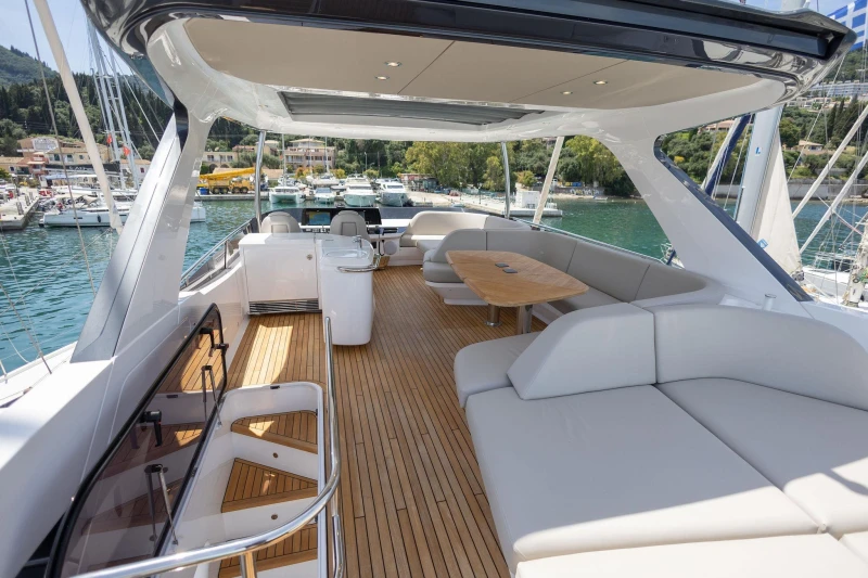 Luxurious 2025 Princess F65 yacht with spacious deck and elegant seating in a marina setting.