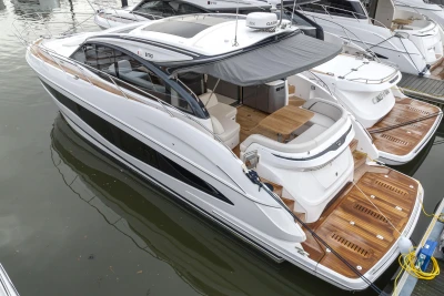 2023 Princess V50 yacht with sleek design, docked in marina.