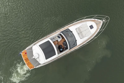Aerial view of 2023 Princess V50 yacht cruising on calm water.