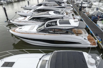 2023 Princess V50 yacht docked among luxury boats in a marina.
