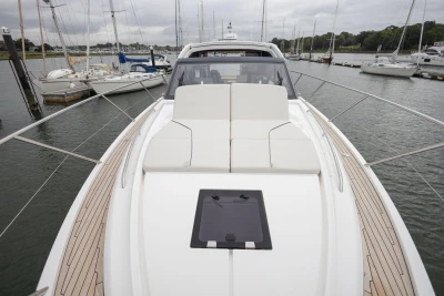 2023 Princess V50 yacht with sleek deck design, docked in a marina.