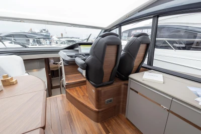Interior of 2023 Princess V50 yacht with modern helm and luxurious seating.