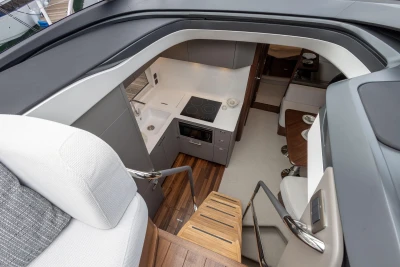 Modern kitchen interior of 2023 Princess V50 yacht with sleek design and wooden accents.
