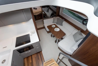 Luxurious interior of 2023 Princess V50 yacht with modern kitchen and cozy seating area.