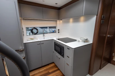 Modern kitchen interior on 2023 Princess V50 yacht with sleek cabinetry and appliances.