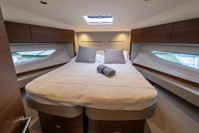 Luxurious cabin interior of 2023 Princess V50 yacht with cozy bed and elegant design.