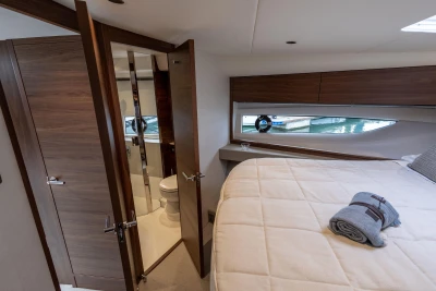 Luxurious bedroom interior of 2023 Princess V50 yacht with modern design and elegant furnishings.