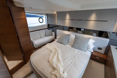 Luxurious bedroom interior of 2023 Princess V50 yacht with elegant bedding and modern design.