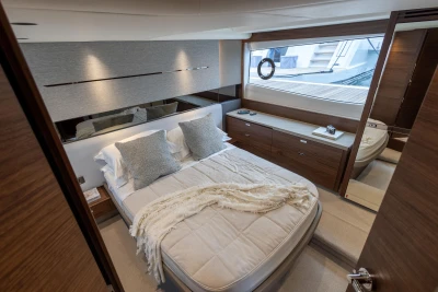 Luxurious cabin interior of 2023 Princess V50 yacht with elegant bedding and modern design.