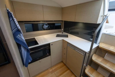 Modern kitchen interior on 2018 Princess V40 yacht, featuring sleek cabinetry and appliances.