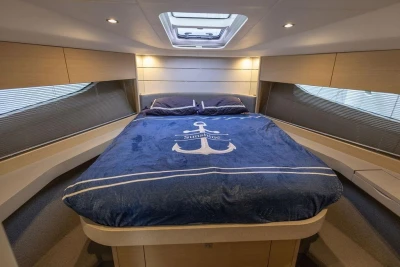 Luxurious cabin interior of 2018 Princess V40 yacht with cozy bedding.