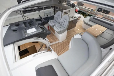 Luxurious 2018 Princess V40 yacht interior with helm, seating, and kitchenette.