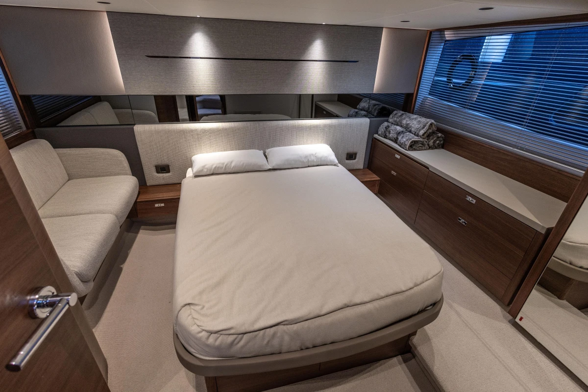 Luxurious bedroom interior of 2024 Princess V50 Open yacht, featuring modern design and cozy furnishings.
