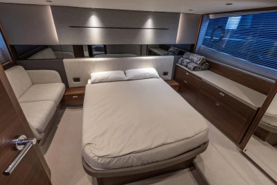 Luxurious bedroom interior of 2024 Princess V50 Open yacht, featuring modern design and cozy furnishings.