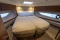 Luxurious cabin interior of 2024 Princess V50 Open yacht with cozy bedding.