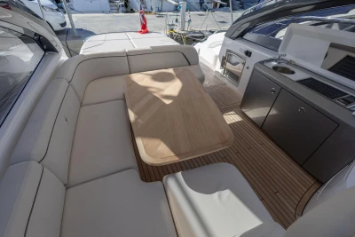 Luxurious 2024 Princess V50 Open yacht interior with elegant seating and kitchenette.
