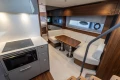 Luxurious interior of 2024 Princess V50 Open yacht with modern kitchen and cozy seating area.