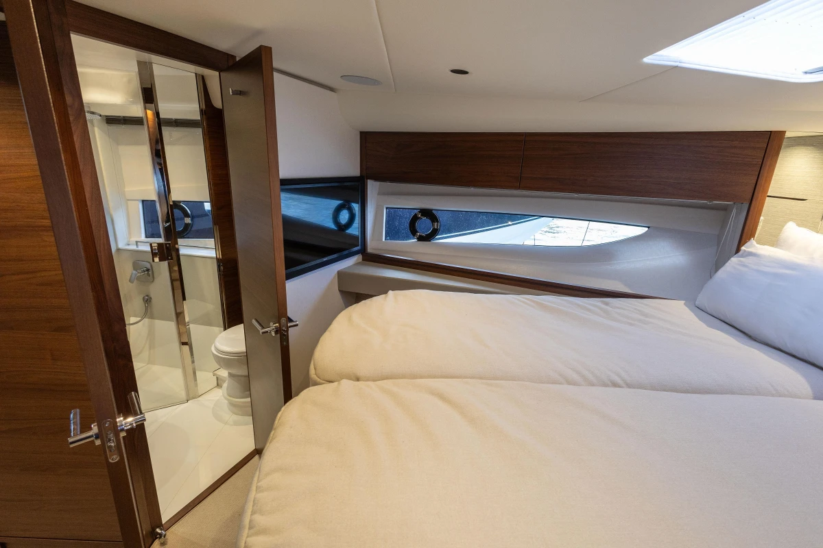 Luxurious 2024 Princess V50 Open yacht cabin with ensuite bathroom and elegant wood finishes.