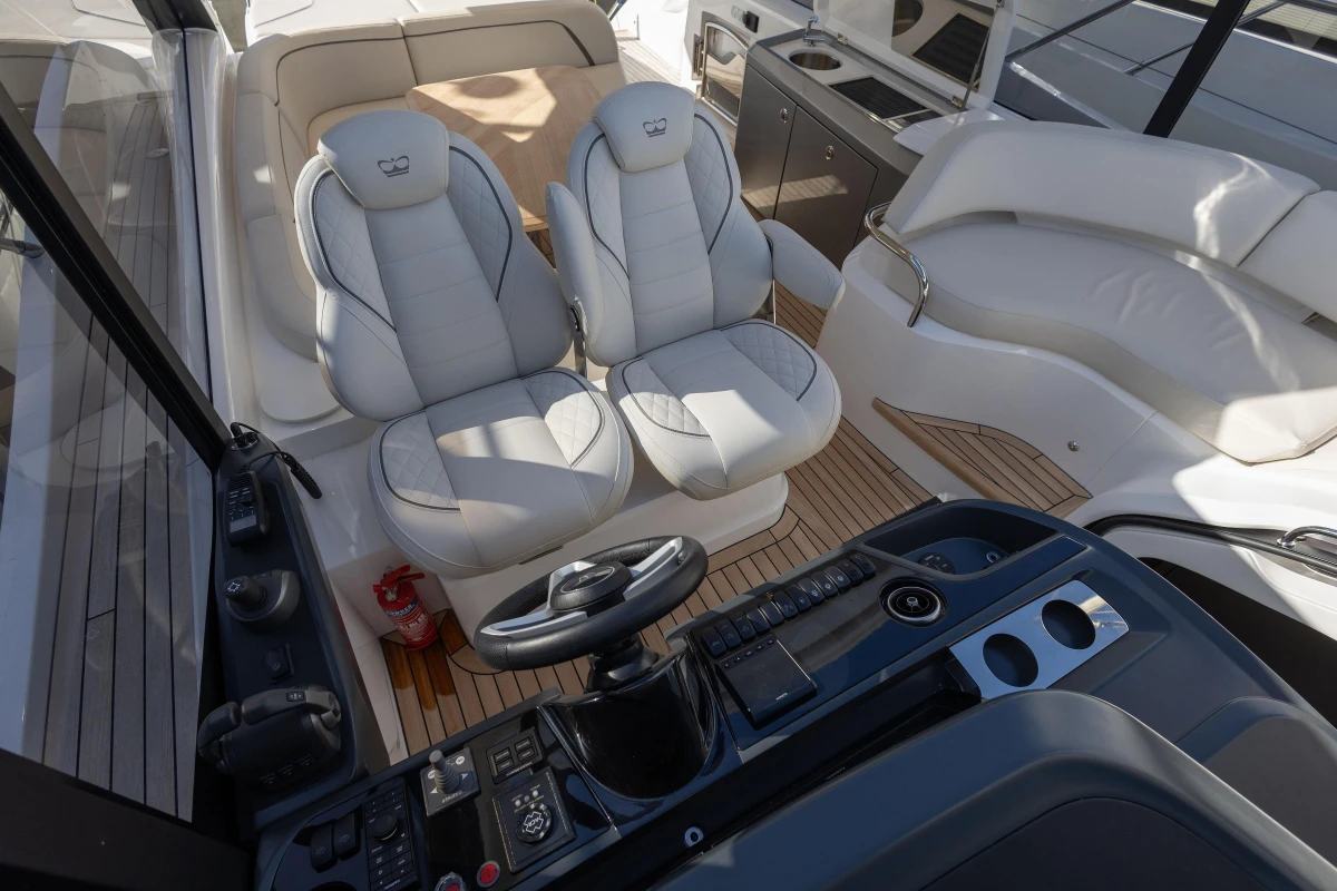 2024 Princess V50 Open yacht interior with luxurious seating and modern helm controls.