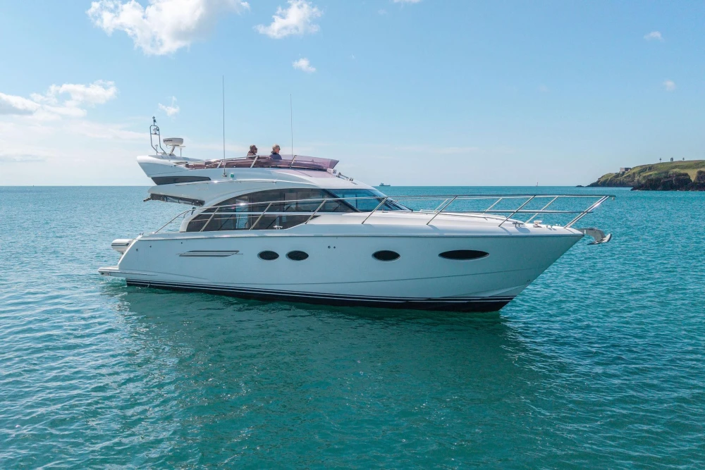 Luxury 2015 Princess 43 yacht cruising on clear blue waters.