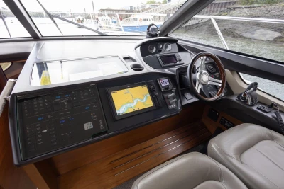Cockpit of 2015 Princess 43 yacht with navigation equipment and steering wheel.