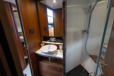 Luxurious bathroom interior on a 2015 Princess 43 yacht, featuring modern sink and shower.