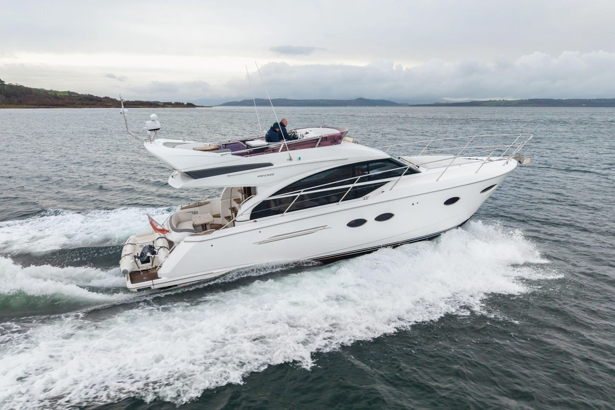 2017 Princess 43 yacht cruising on open water, showcasing sleek design and luxury.