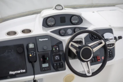 Control panel of a 2017 Princess 43 yacht with steering wheel and navigation instruments.