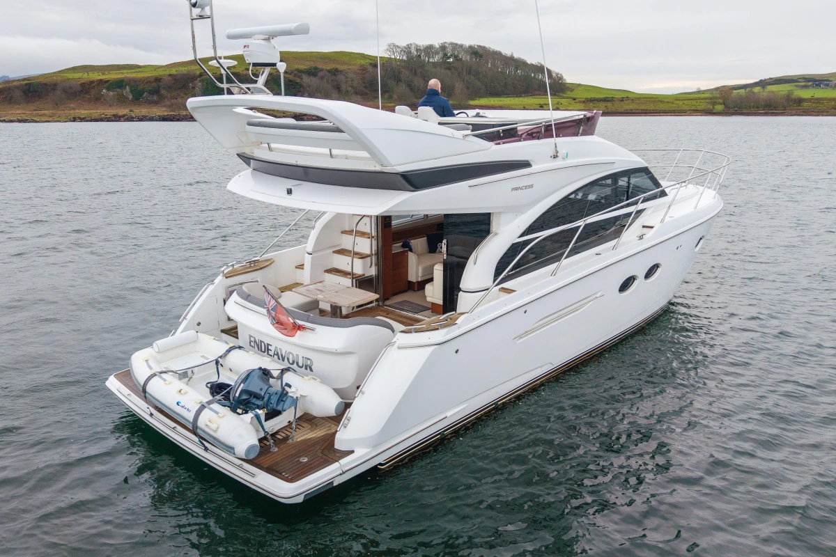 Luxury 2017 Princess 43 yacht on serene water, showcasing elegant design and spacious deck.