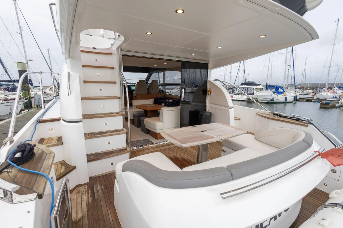 Luxurious 2017 Princess 43 yacht with elegant seating and marina view.