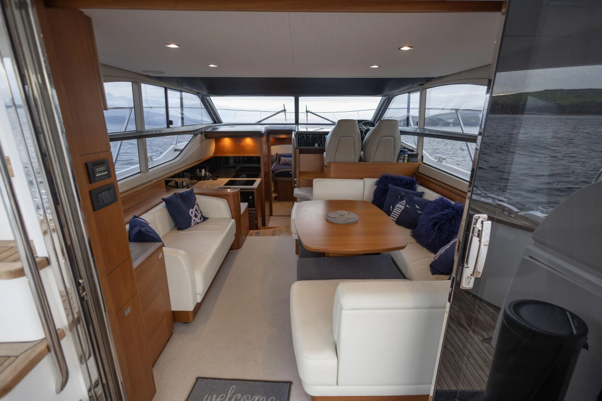 Luxurious interior of a 2017 Princess 43 yacht with elegant seating and dining area.