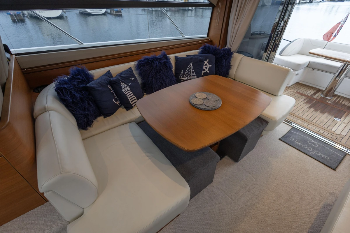 Luxurious interior of 2017 Princess 43 yacht with elegant seating and nautical-themed cushions.
