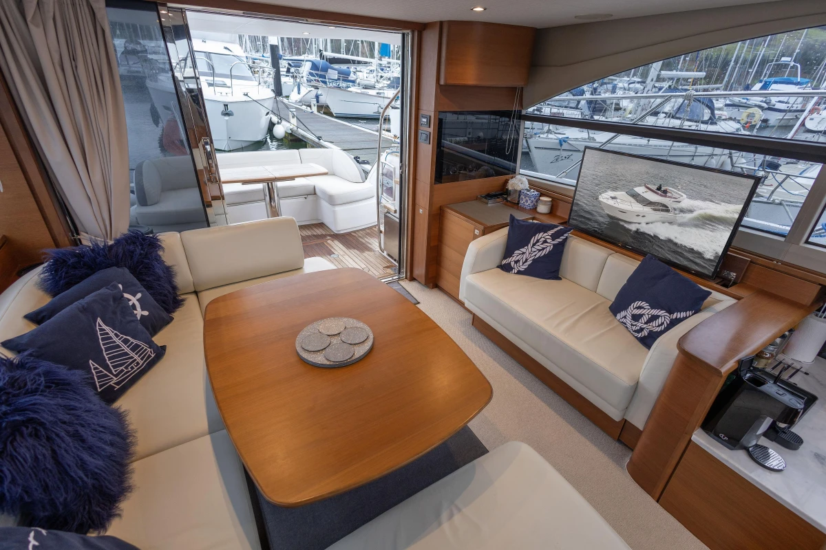 Luxurious interior of 2017 Princess 43 yacht with elegant seating and marina view.