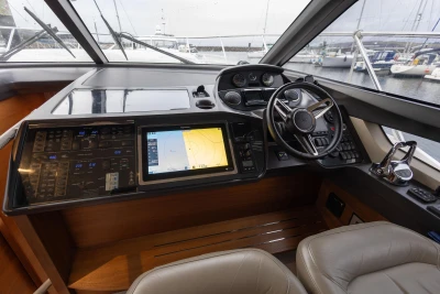 Luxurious helm of 2017 Princess 43 yacht with advanced navigation controls and leather seating.
