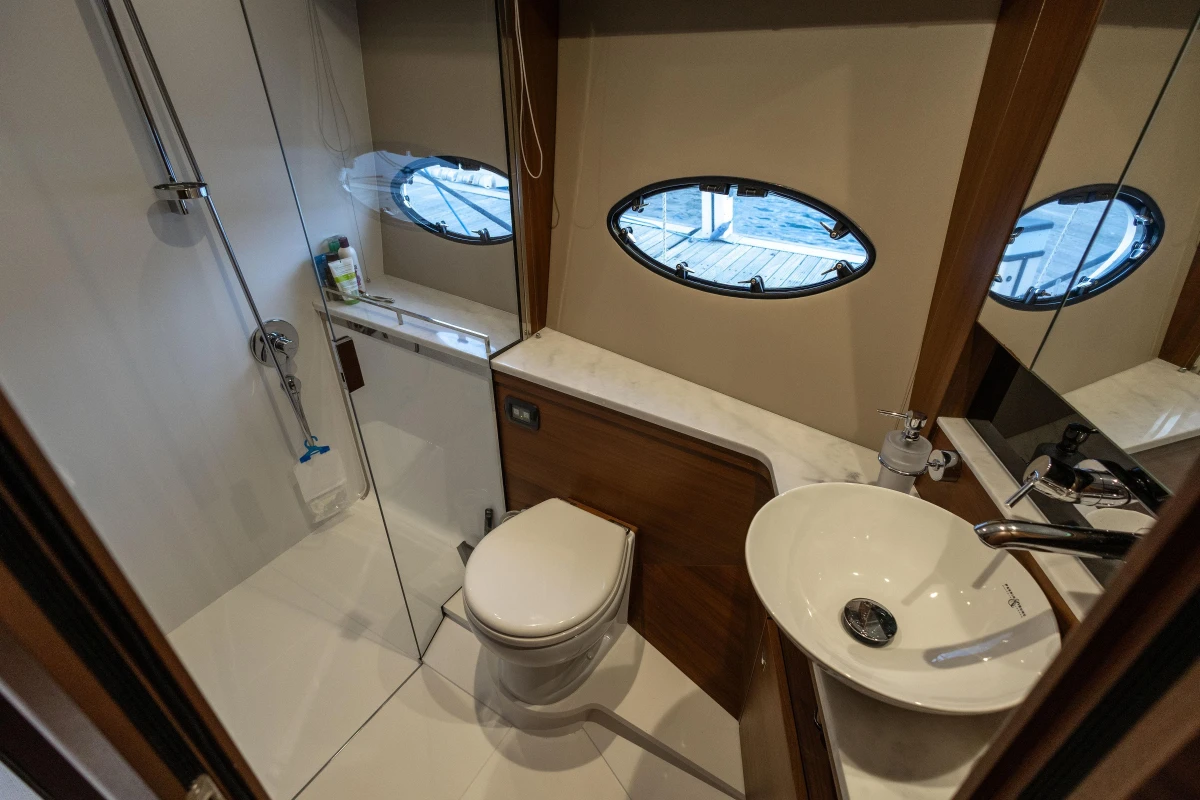 Luxurious bathroom in 2017 Princess 43 yacht with modern fixtures and porthole window.