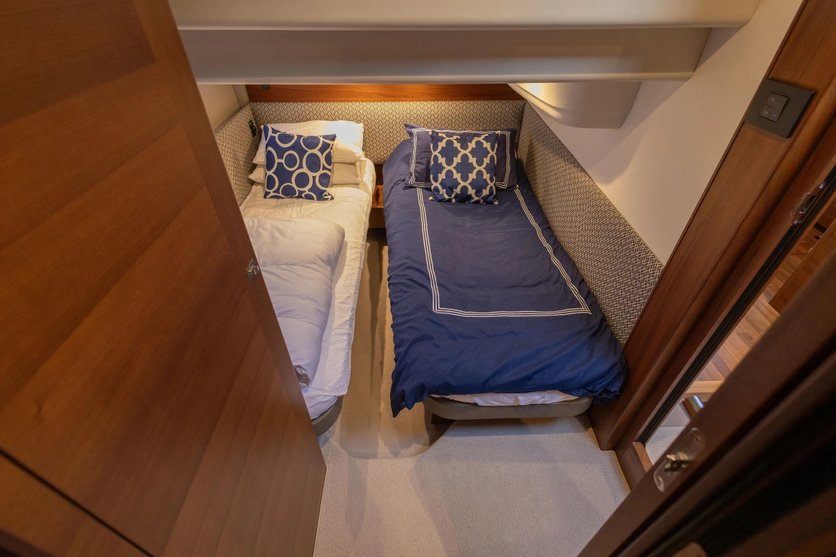 Cozy twin cabin in 2017 Princess 43 yacht with stylish bedding.