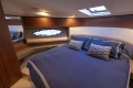 Luxurious cabin interior of 2017 Princess 43 yacht with elegant bedding and wood accents.