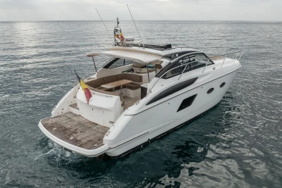 2014 Princess V39 yacht cruising on open water, rear view.