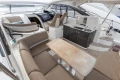 Luxurious 2014 Princess V39 yacht interior with seating, table, and kitchenette.