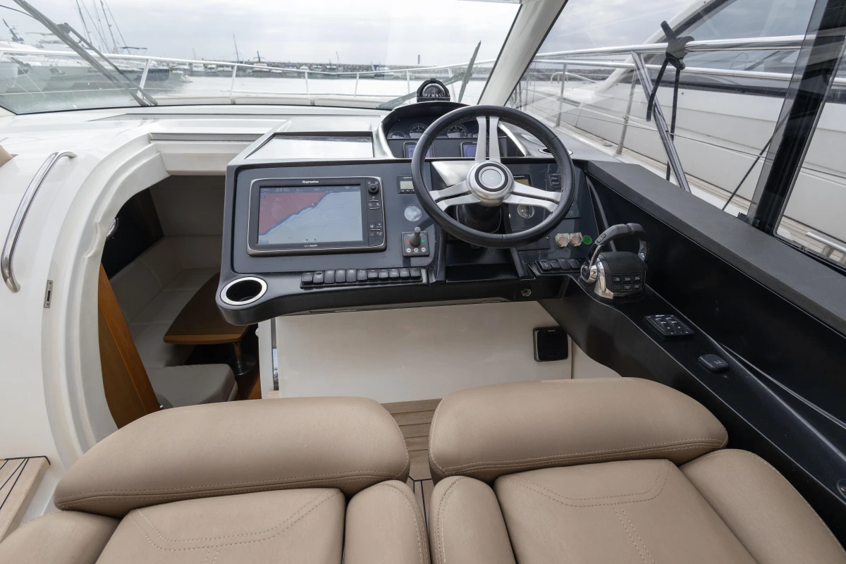 Helm of 2014 Princess V39 yacht with navigation system and steering wheel.