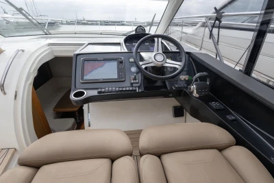 Helm of 2014 Princess V39 yacht with navigation system and steering wheel.