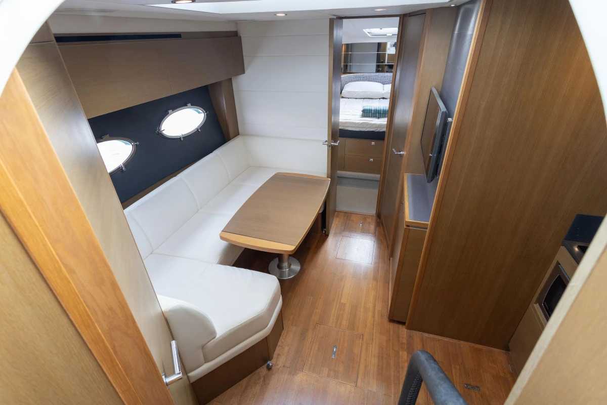 Luxurious interior of 2014 Princess V39 yacht with elegant seating and wooden finishes.