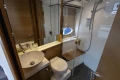 Luxurious bathroom in 2014 Princess V39 yacht with modern fixtures and porthole window.