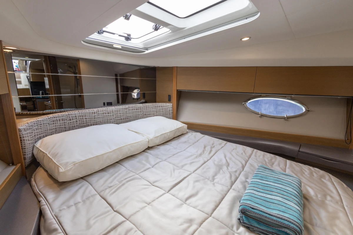 Luxurious cabin interior of 2014 Princess V39 yacht with bed and porthole.