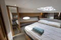 Luxurious cabin interior of 2014 Princess V39 yacht with cozy bed and modern design.