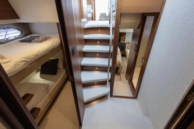 Luxurious interior of 2018 Princess 49 yacht with cozy cabins and elegant staircase.