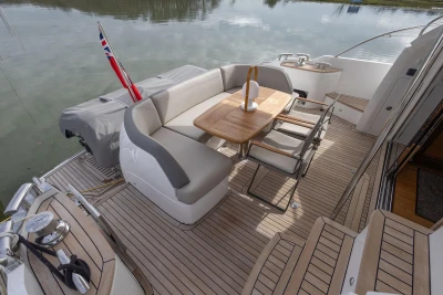 Luxurious 2018 Princess 49 yacht deck with elegant seating and dining area.